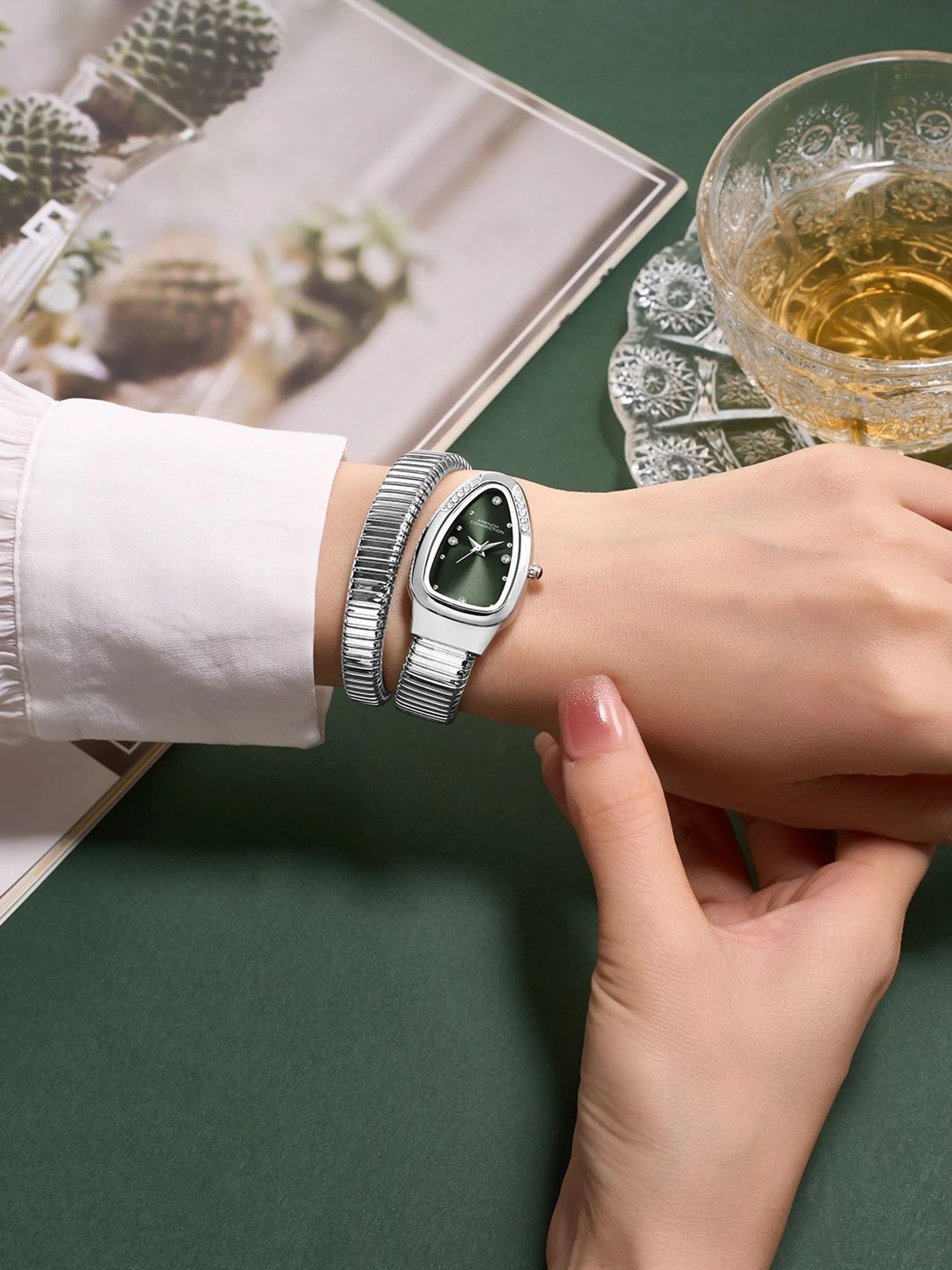 French Connection The Mystic Curve Women's Silver Watch | Rhinestones Green Sunray Dial Analog Watch – For Women FCN0110NSM